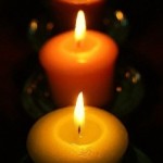Closeup of Lit Candles in the Dark