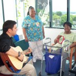 Patient with Tambourine and Guitarist Sitting with Caretaker
