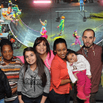 Large Group Smiling in Front of Clowns Running in a Skate Ramp