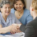 Daughter with Mother Shaking Hands with Employee