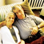 Older Couple Reclining Together on Couch